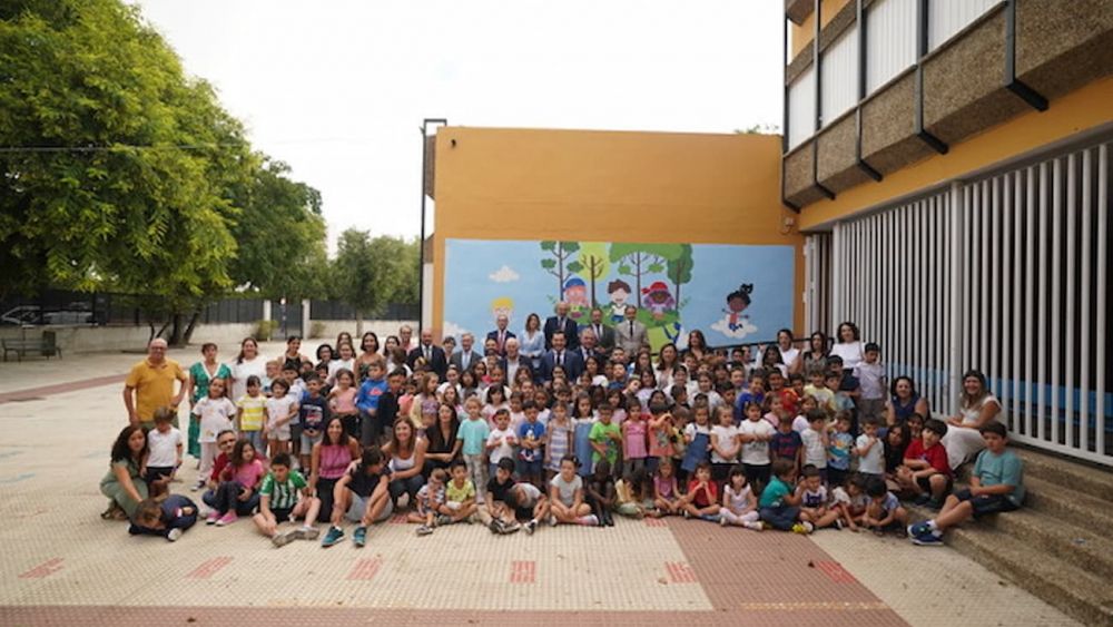 Los únicos árboles del patio del CEIP Juan Ramón Jiménez de Sevilla son los pintados en un mural situado tras Moreno Bonilla, la consejera, los alumnos y profesores, en la foto de familia de este lunes.