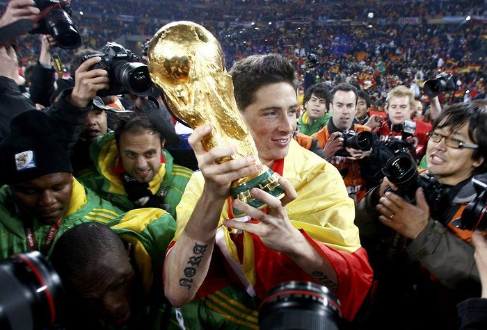 Spain's Torres holds the World Cup trophy after their final match victory over Netherlands at the 2010 World Cup in Johannesburg